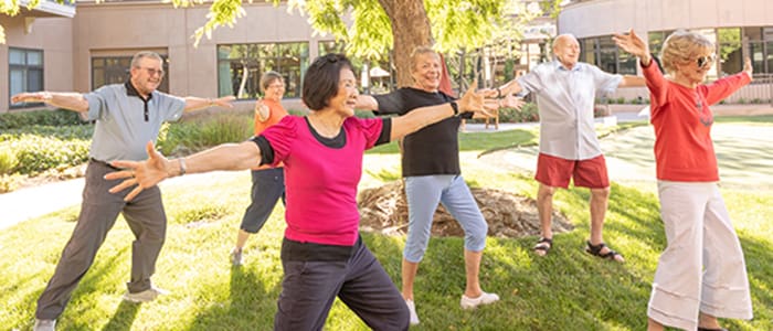 Residents taking part in outdoor yoga at Walnut Village