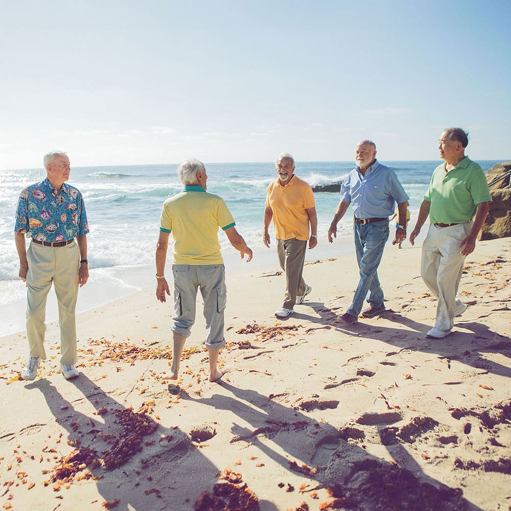 Gathering of senior residents on beach at Casa de Mañana