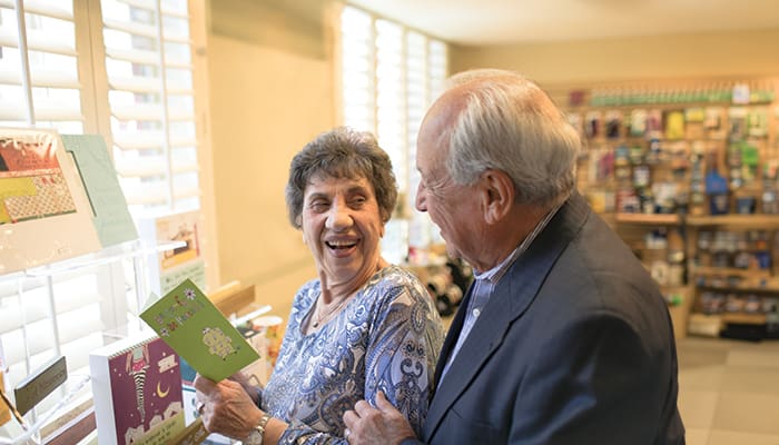 Portrait of a smiling couple enjoying independent living at Claremont Manor