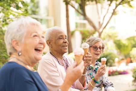 Smiling women eating ice cream