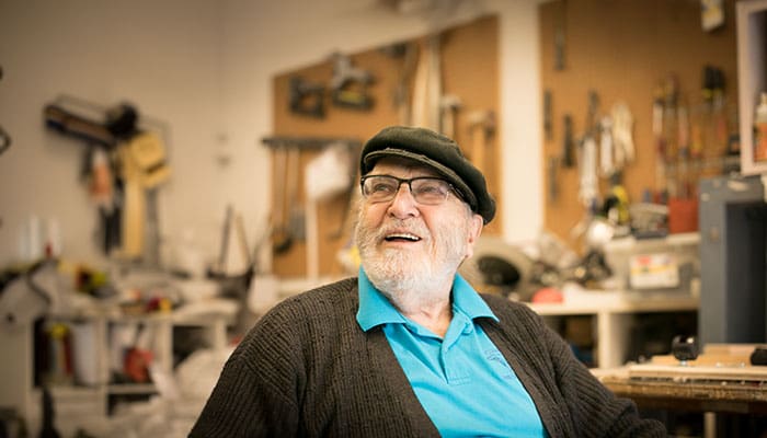 Smiling senior man in tool workshop