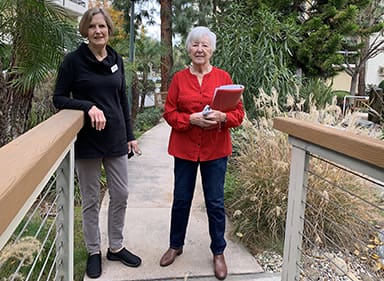 Mentor Olive Harkness, right, shows Lyssa Axeen around Villa Gardens.
