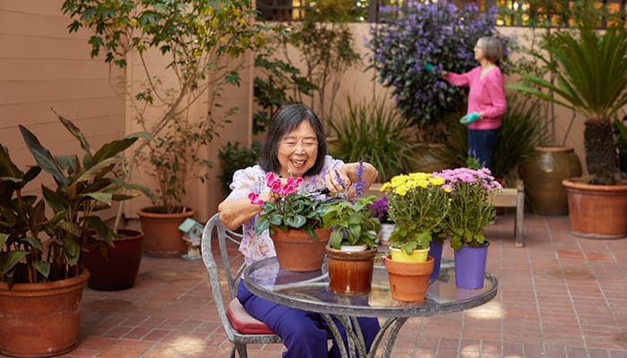 A Webster House resident tending to plants