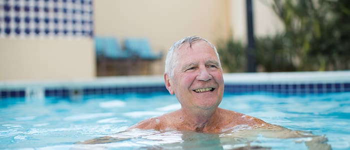 Portrait of senior man smiling in the pool at Carlsbad by the Sea