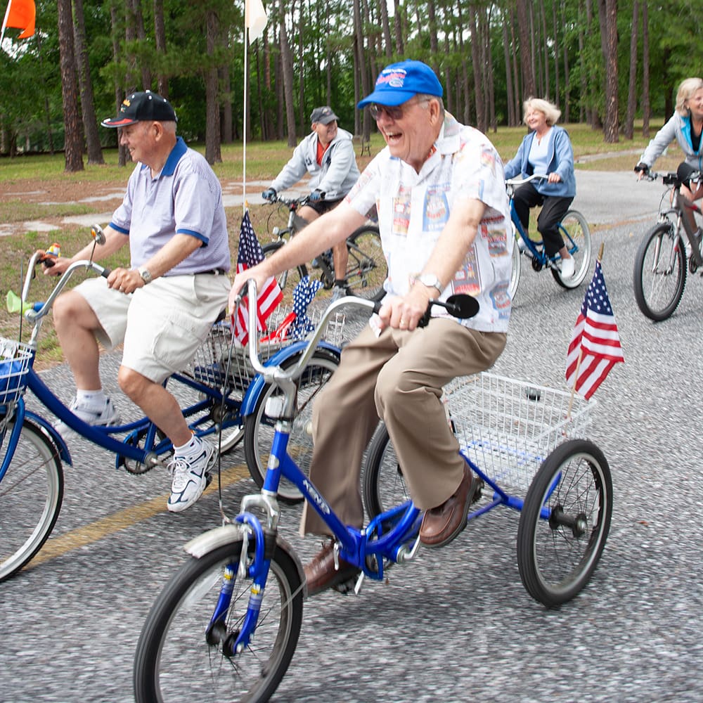 Photograph of smiling group outdoors on bicycles