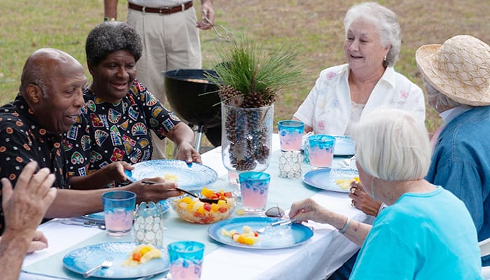 Group of smiling Cecil Pines residents during a social gathering