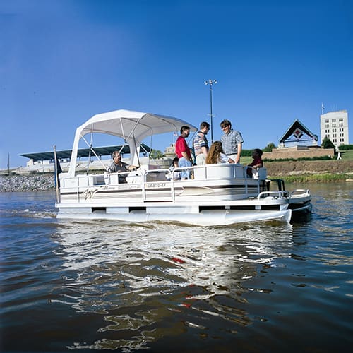 Photograph of group riding on a pontoon boat