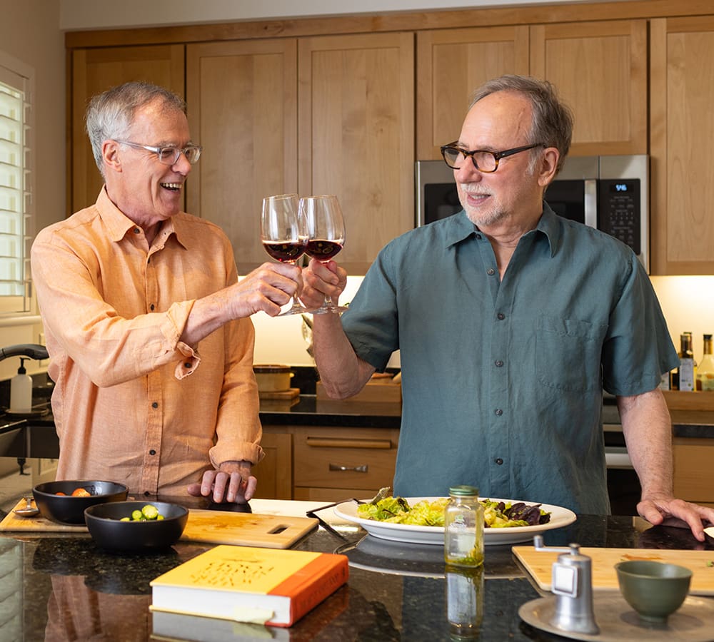 Two Spring Lake Village residents celebrating in their kitchen