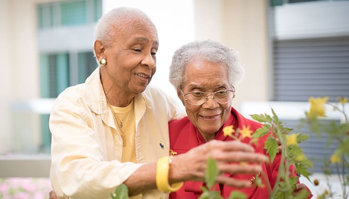 Closeup of two Villa Gardens residents smiling