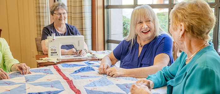 Residents photographed during sewing class