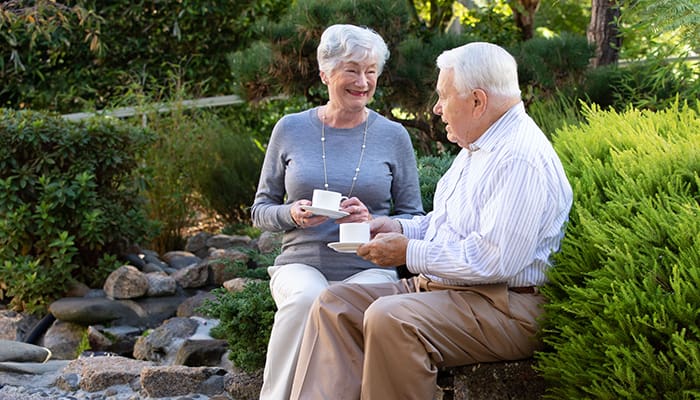 Woman and man enjoying coffee outdoors