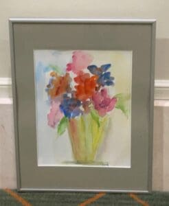 A framed water color painting of a vase of flowers