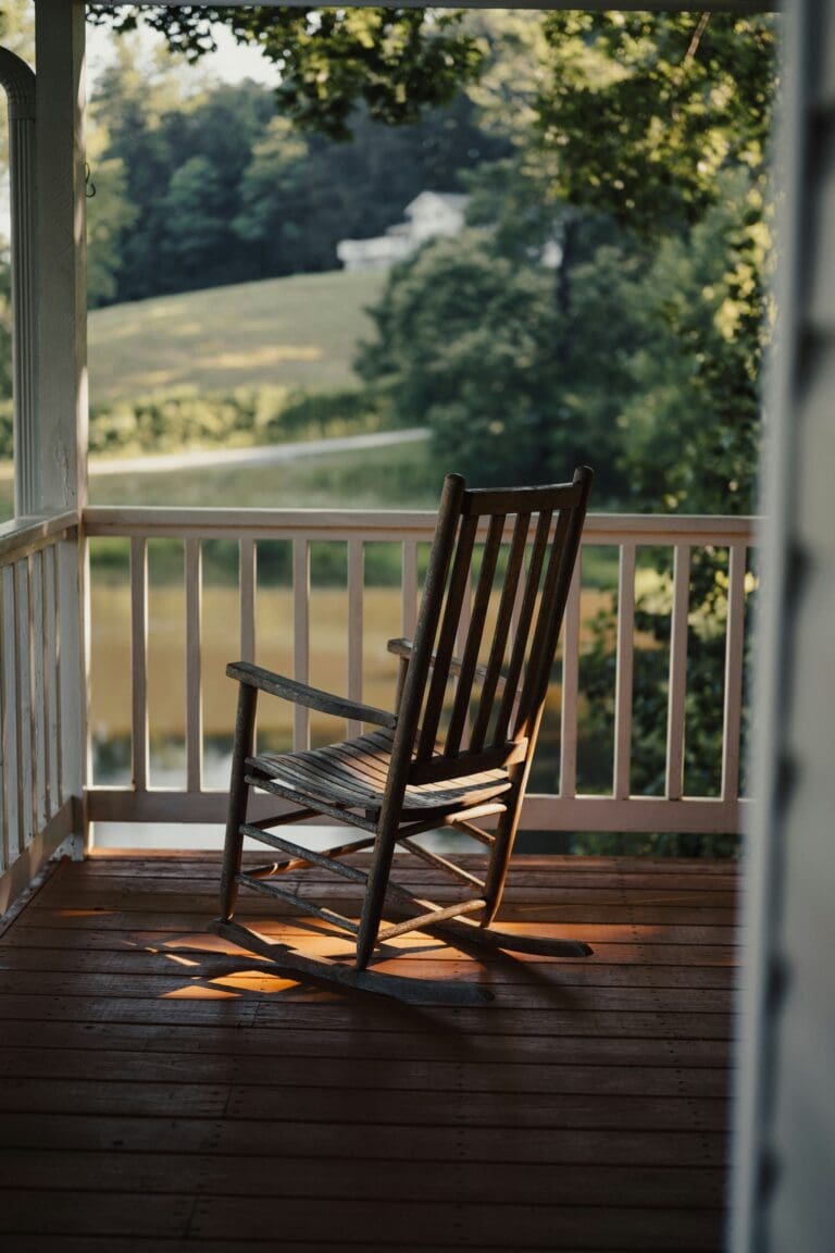 Single rocking chair on porch
