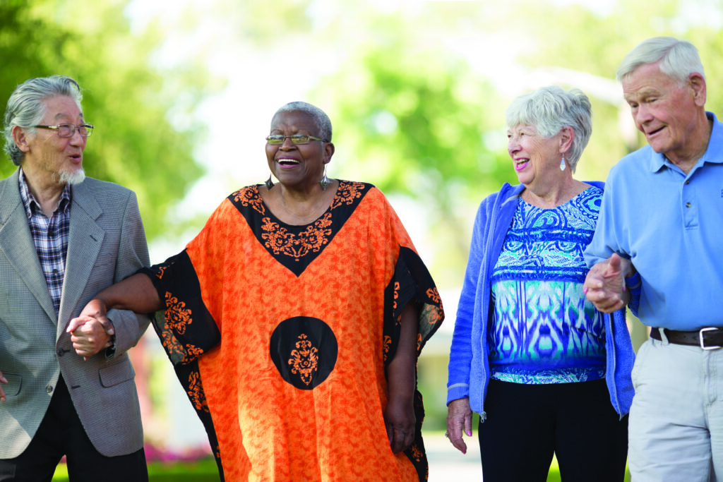 Four residents walk through Claremont Manor