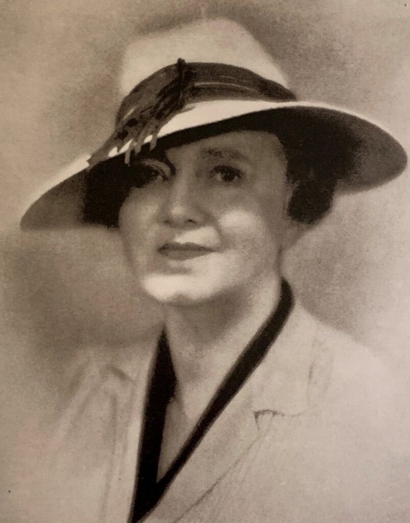 Portrait of Isabel Hopkins, a woman wearing a hat.