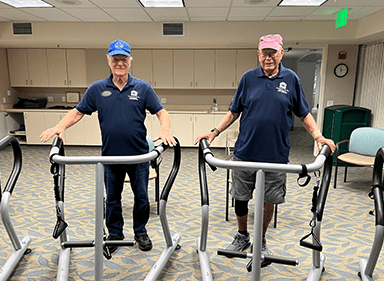 Two men wearing matching polos stand in S3 Balance devices.