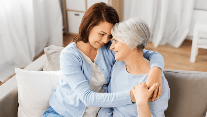 a senior lady hugging her daughter