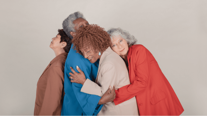 a group of ladies hugging each other