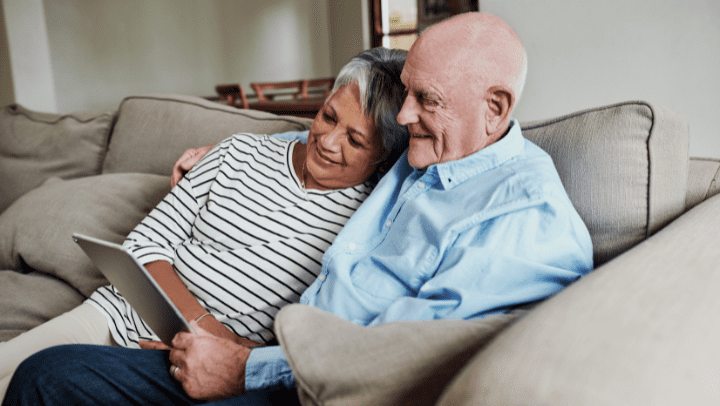 an elderly couple hugging