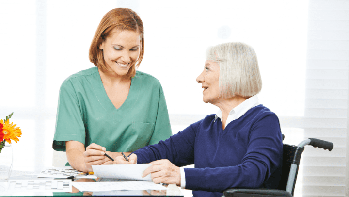 a nurse helping an old lady