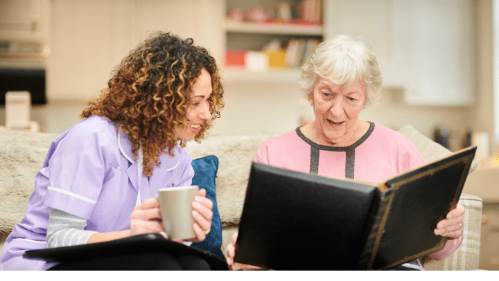 a nurse reading with an old lady