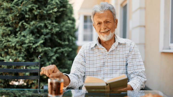 an old man reading a book