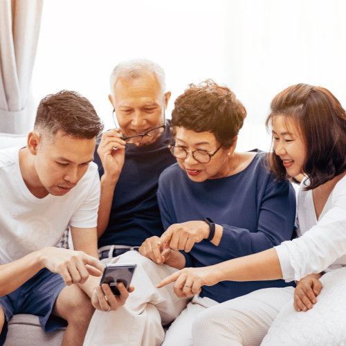 grandkids helping grandparents with a phone