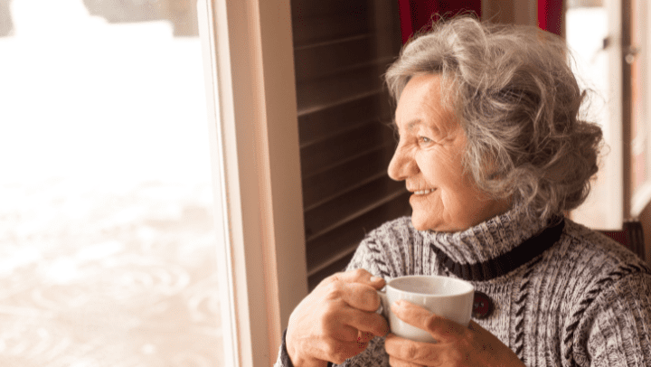 a senior looking through a window