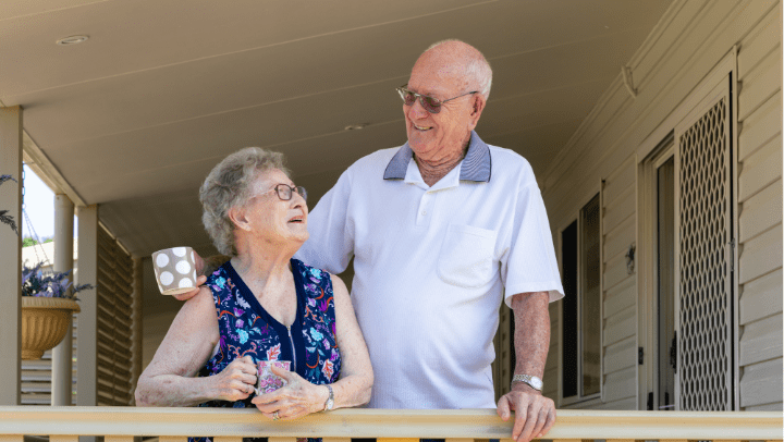 a senior couple smiling at each other