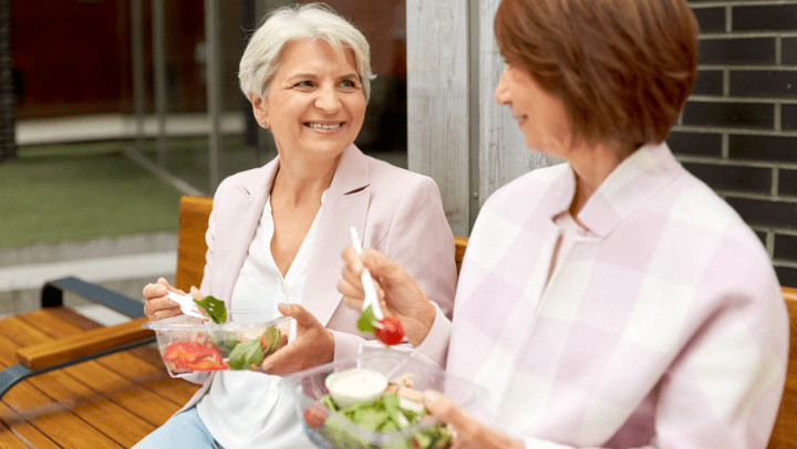 two ladies eating salads 