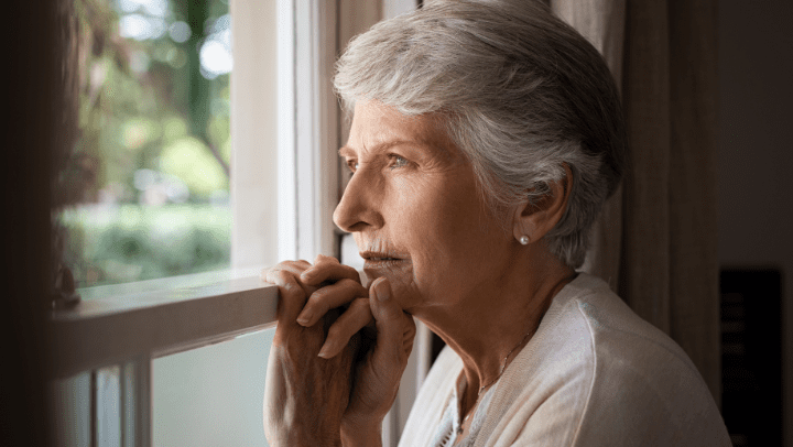 a woman alone looking out the window