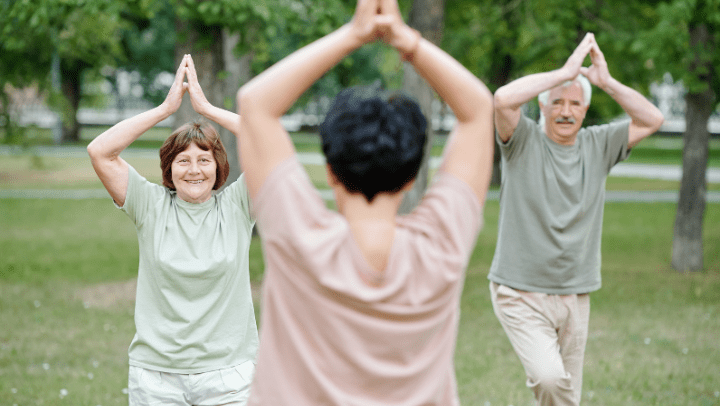 a group of seniors making yoga