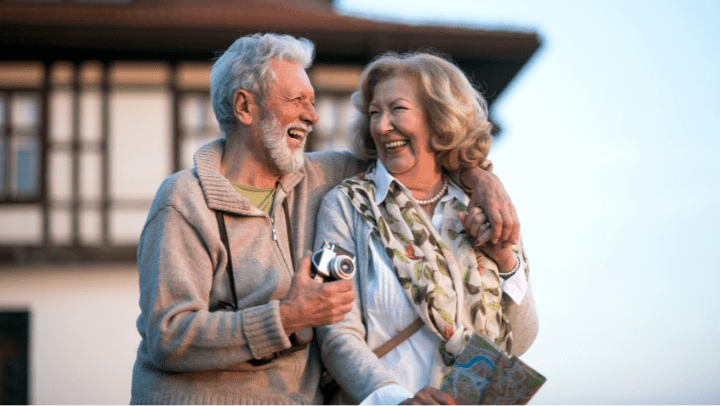 a couple of seniors laughing an hugging each other