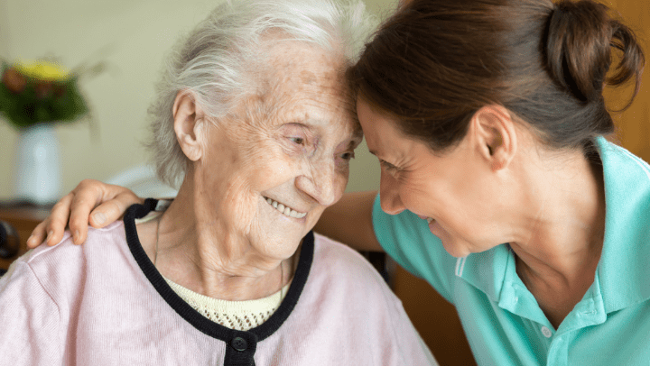 a nurse and an old lady hugging each other