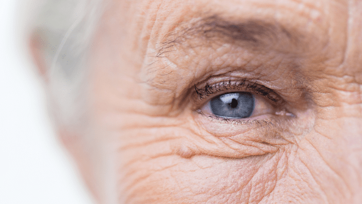 A close-up of an older lady's blue eye.