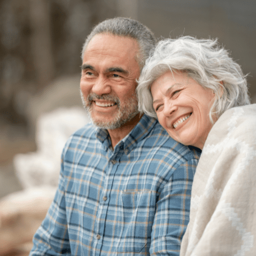 elderly couple together with woman laying her head on mans shoulders