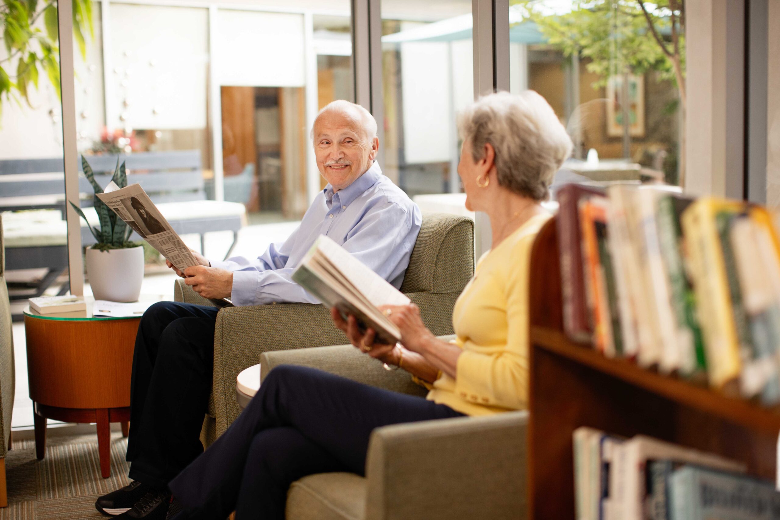 two seniors reading in independent living