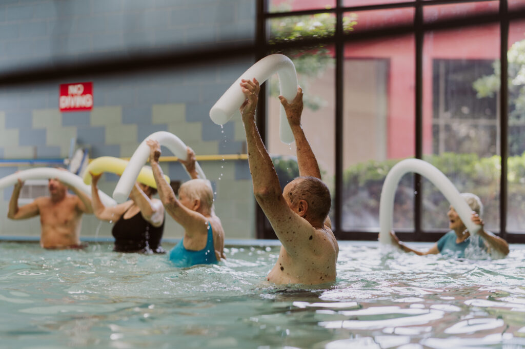 older people dancing in the water