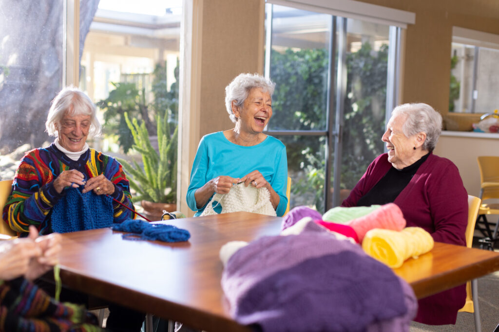 seniors knitting and laughing