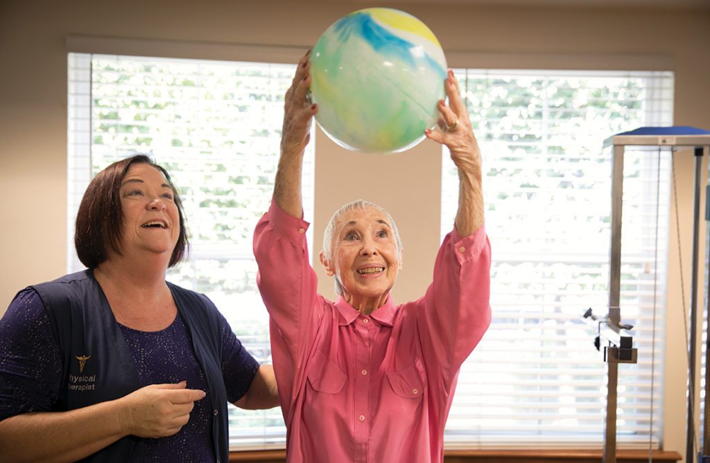 a senior lady playing with a ball