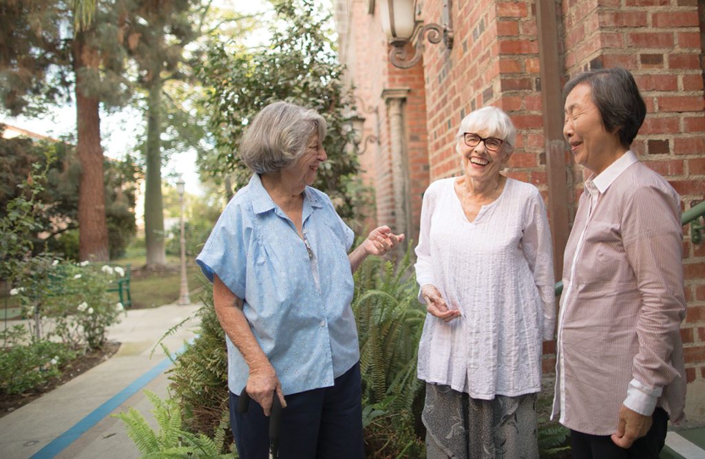 three senior ladies laughing each other