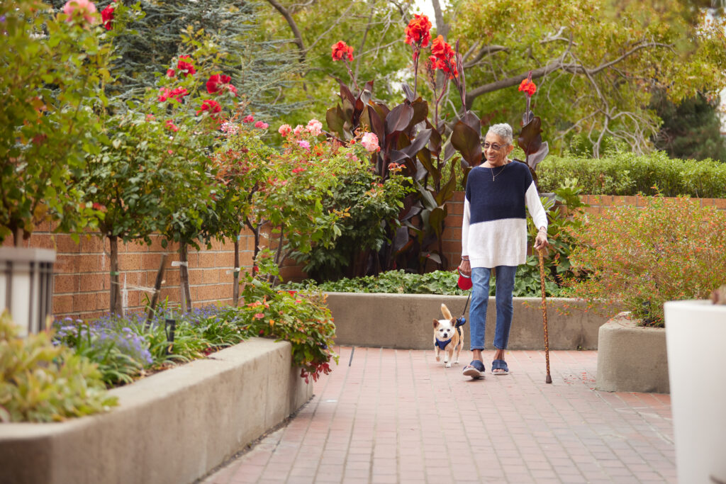 a woman walking with a little dog