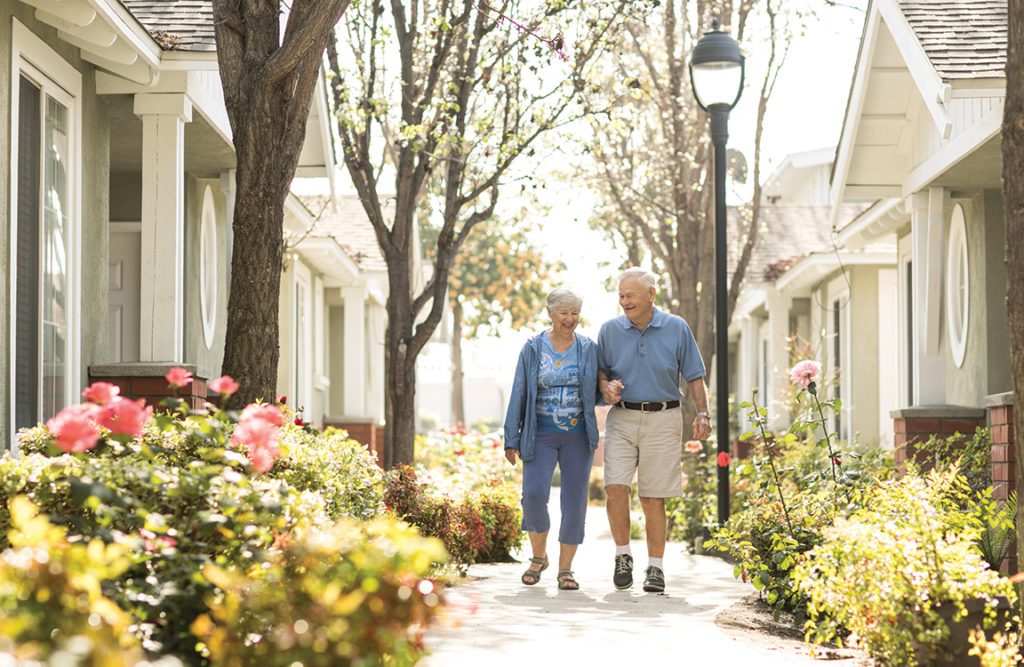 a couple walking in a senior living community