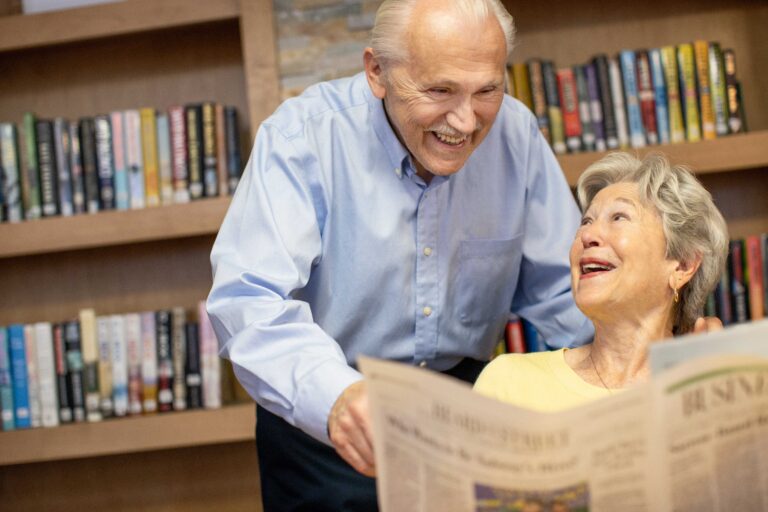 two seniors reading the newspaper