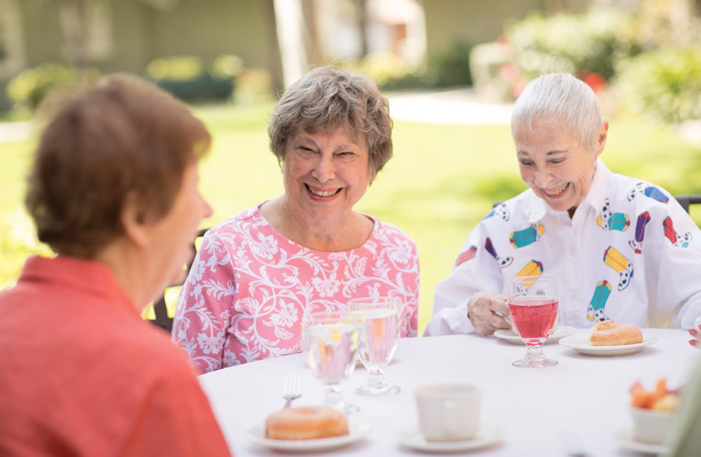 a group ladies chatting and eating