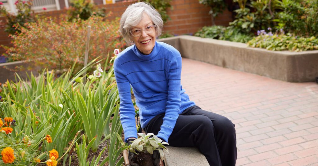 an old lady outside in the garden