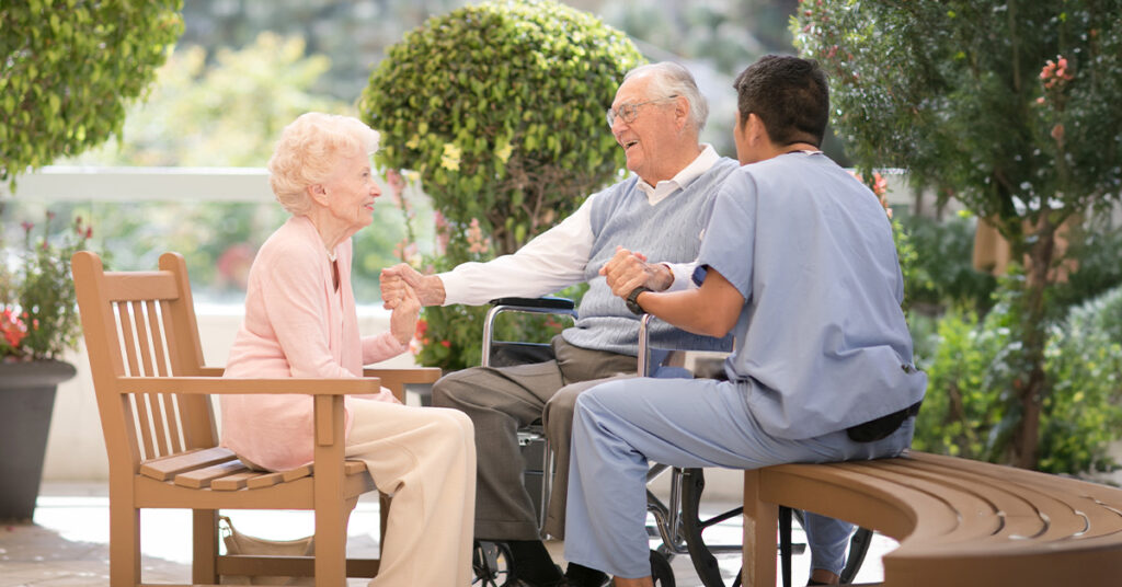 senior couple with caregiver