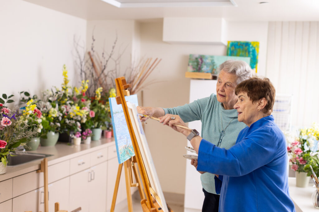 two old ladies painting at independent living