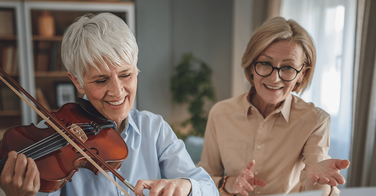 two senior ladies playing violin