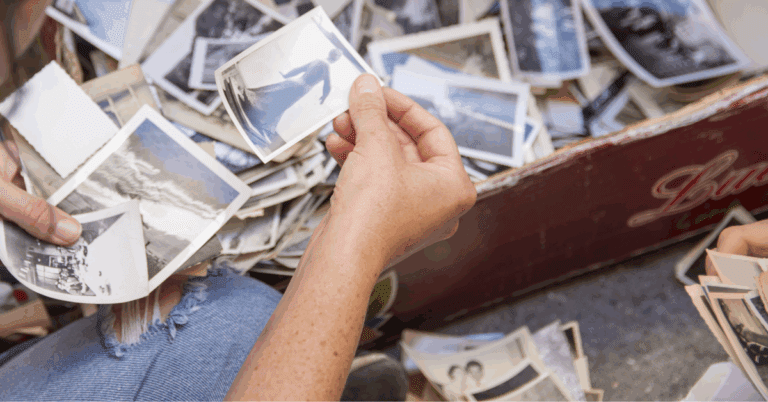an elderly man looking at his family photo album